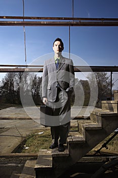 Young Businessman Standing on Stairs