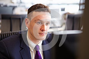 Young businessman staring at computer screen