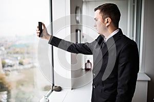 young businessman in a stylish modern office space with large wind