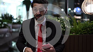 Young businessman in suit asleep and startled when someone called