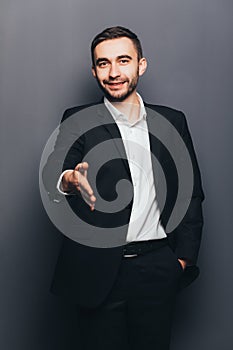 Young businessman in suit give hand shake