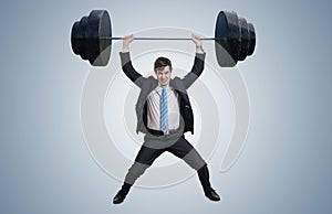 Young businessman in suit is lifting heavy weights.