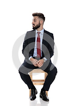 Young businessman in suit looking to side