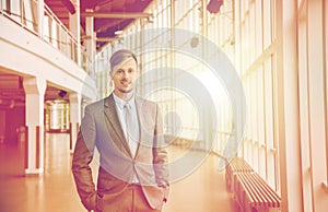 Young businessman in suit at office building hall