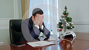 Young businessman in a suit rubs his nose, looking down have no idea and tired. We understand from his face that he was