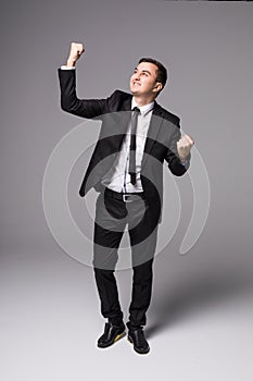 Young businessman in suit winner victory celebrate