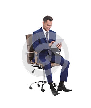 Young businessman with tablet sitting in comfortable office chair