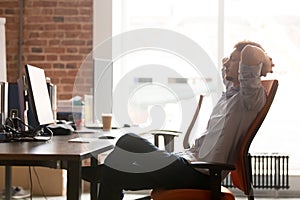 Young businessman taking break at work relaxing in ergonomic chair