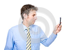 Young businessman taking photo with his smartphone