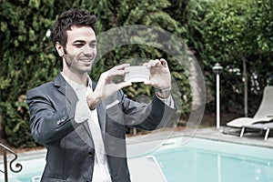 Young Businessman Taking Photos with Mobile