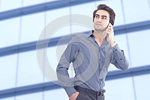 Young businessman talking mobile phone