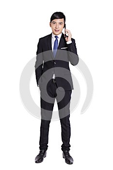 Young businessman talking on the mobile phone.Full length portrait.Isolated on white background