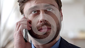 Young businessman talking phone at remote office. Close up guy calling phone.