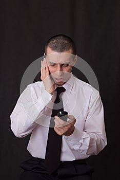 Young businessman talking on two phones