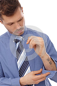 Young businessman with tattoo in forearm photo