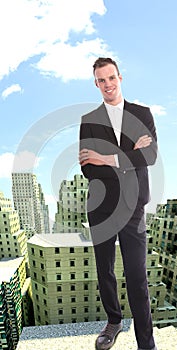 Young businessman on top of rendered building