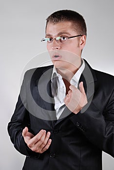 Young businessman touching his shirt nervously