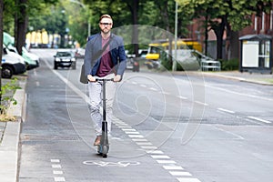 Young Businessman Travel With Electric Scooter