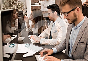 Young businessman typing on the computer keyboard.