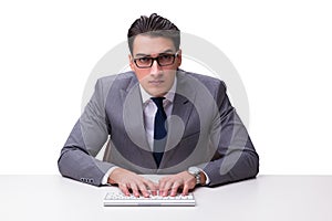 Young businessman typing on a keyboard isolated on white backgro