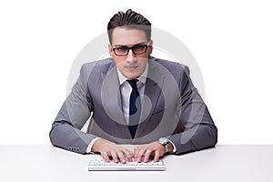 Young businessman typing on a keyboard isolated on white backgro