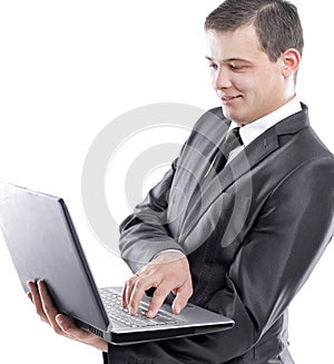 Young businessman typing on laptop.isolated on white