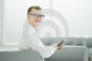 Young businessman typing SMS on his smartphone.