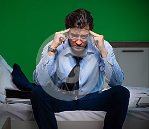 Young businessman under stress in the bedroom at night