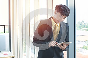 Young businessman use digital tablet in workplace