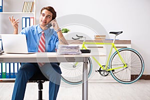 The young businessman using bike to commute to the office