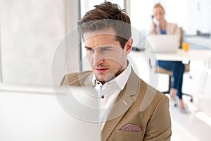 Young businessman using computer in new office