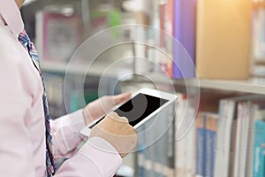 Young businessman using computer tablet in hand, use smartphone as computer online search for finding information, study and