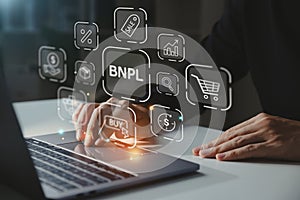 Young businessman using laptop with BNPL icon