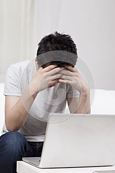 Young businessman using a laptop in sofa