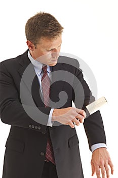 Young businessman using lint brush photo