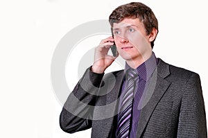 Young businessman in violet tie speaks by phone