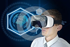 Young businessman with VR glasses on a digital earth interface background