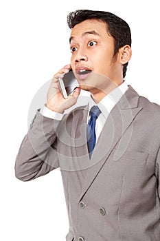 Young businessman was surprised to receive a phone