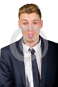 Young businessman wearing a suit shows tongu