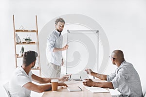 young businessman at white board making presentation