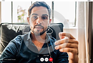 Young businessman on a work video call while staying at home.