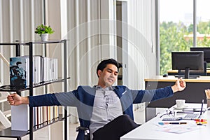 Businessman worker taking break at work relaxing sitting in ergonomic chair at office desk resting finished computer work