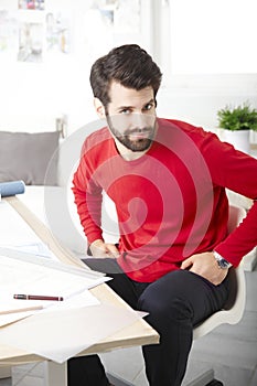 Young businessman working in architect studio