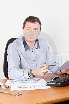 young businessman working at desk in office