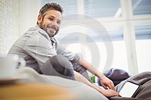 Young businessman working digital tablet in creative office