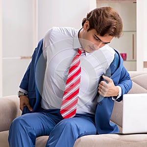 Young businessman working at home sitting on the sofa