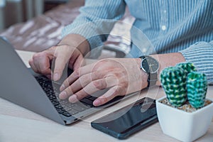 Young businessman working on laptop in home,