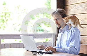 Young businessman is working on a laptop on an open terrace, kit