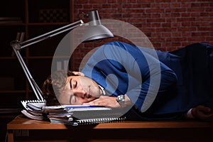 The young businessman working in the office at night