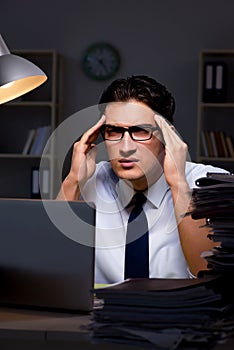 The young businessman working overtime late in office